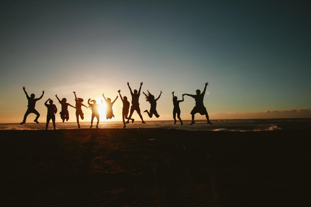 The SUP SUP Squad jumping at sunset